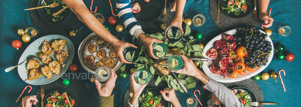 Company of friends gathering for Christmas dinner, wide composition - Stock Photo - Images