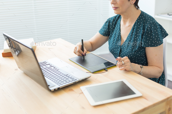 Illustrator, web designer and artist concept - Graphic designer using her pen tablet in a bright
