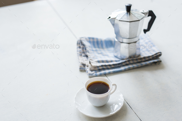 Cup and Coffee Pot with Coffee on White Table Stock Image - Image