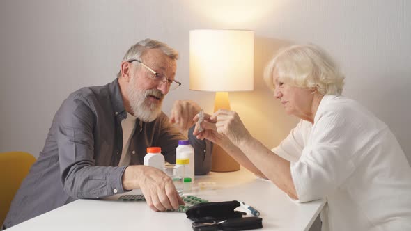 Funny Elderly Couple Arguing Over the Pills That an Elderly Man Needs to Take
