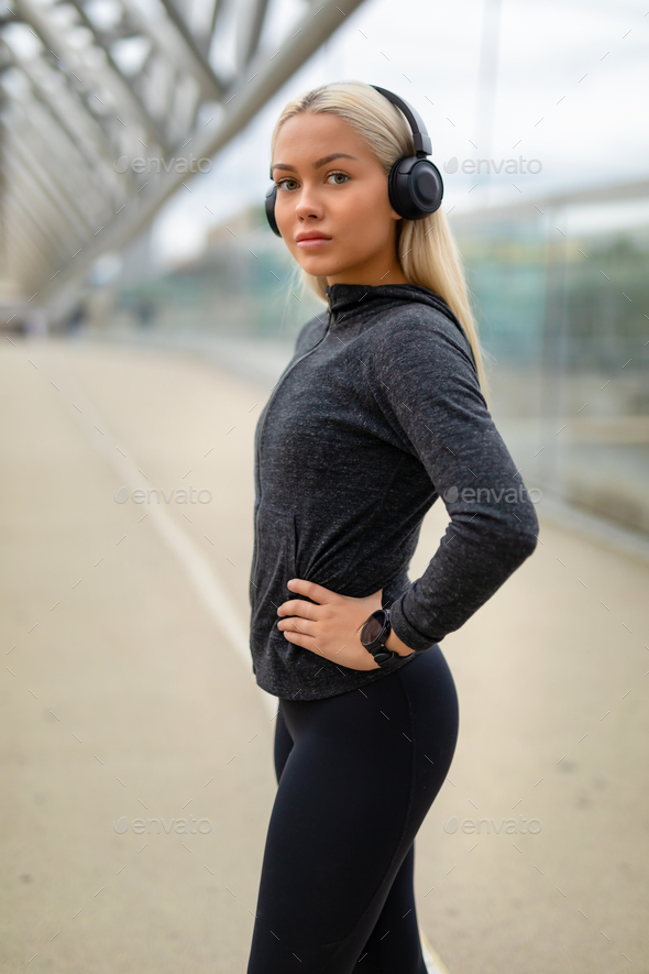 Close-up in Workout Outfit Listen To Music on Headphones Stock Photo by kjekol