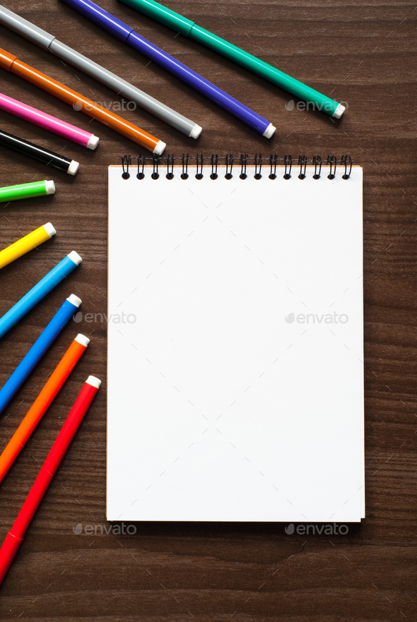 A set of markers and sketch pad Stock Photo by Nadianb