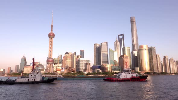 View on Lujiazui Skyline and Huangpu River with Barges at Sunset, Shanghai, China