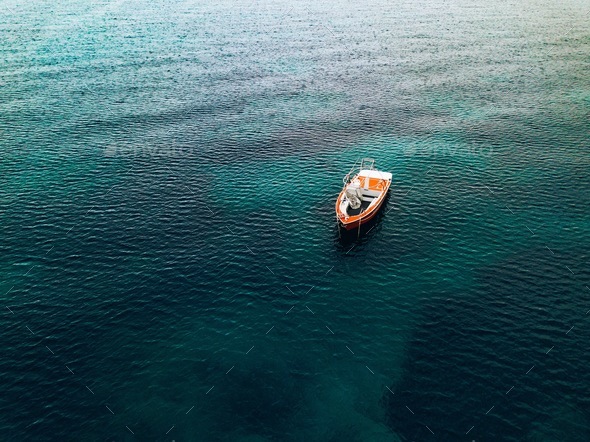 Aerial view of small fishing boat at sea, Greece. Stock Photo by nblxer