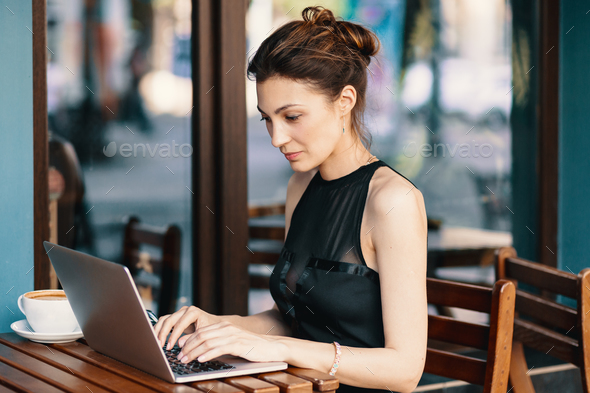 Refined business woman in glasses, sitting at table in cafe work Stock ...