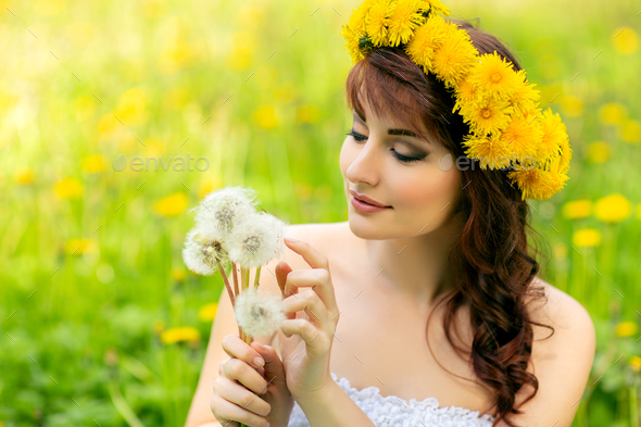 beautiful girl with dandelion flowers in green field Stock Photo by ...