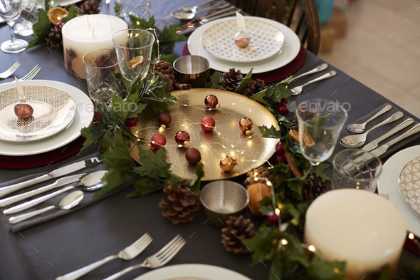 Christmas table setting with bauble name card holders arranged on plates - Stock Photo - Images