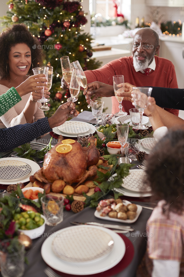 Black Grandfather Making A Toast With His Family At The Christmas Dinner Table Elevated View Stock Photo By Monkeybusiness