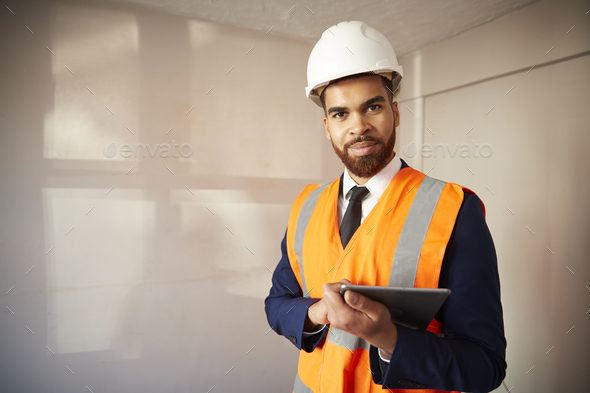 Portrait Of Surveyor With Digital Tablet Carrying Out House Inspection