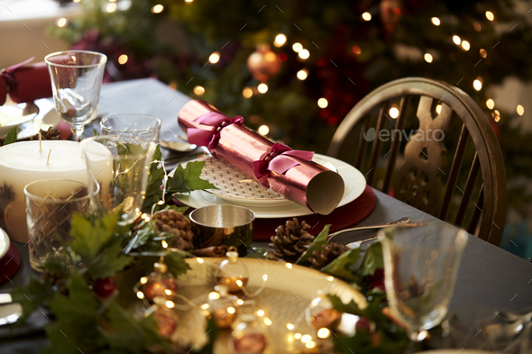 Christmas table setting with a Christmas cracker arranged on a plate - Stock Photo - Images