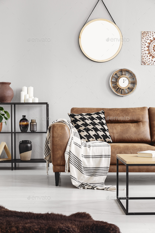 Vertical view of warm ethno living room with leather couch with - Stock Photo - Images