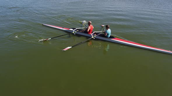 Senior caucasian man and woman rowing boat on a river alt