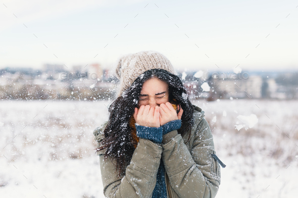 Smiling Woman Feeling Cold Snowflakes On Her Face During A Snow Stock