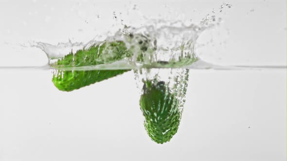 Super Slow Motion Cucumbers Fall Into Water with Splashes alt