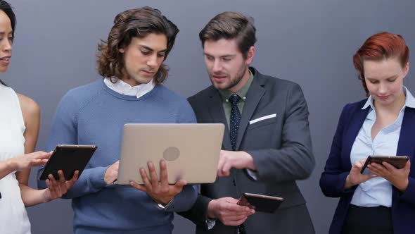 Group of executives using laptop and digital tablet 4k alt