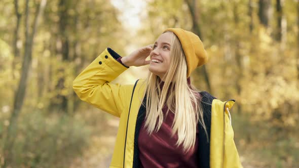 Blonde Woman Walking in The Autumn Forest