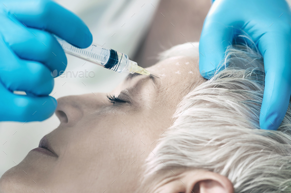 Botulinum Toxin Injections. Senior Woman Receiving Botulinum Tox - Stock Photo - Images