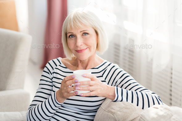 Mature woman drinking fresh morning coffee at home Stock Photo by ...