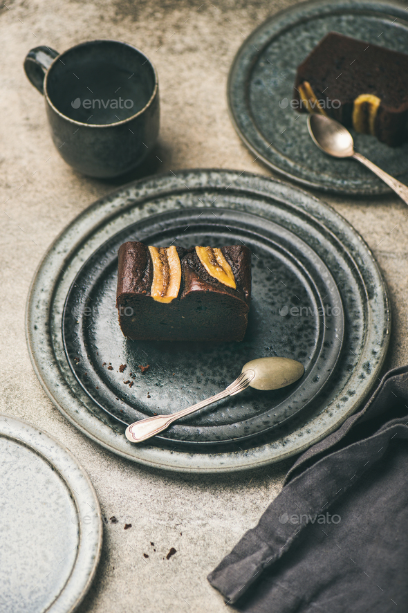 Pieces of dark chocolate banana bread cake on plates - Stock Photo - Images