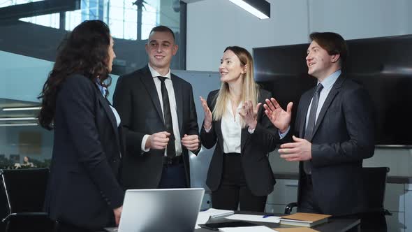 Successful Business Team Reacting with Joy in Office alt
