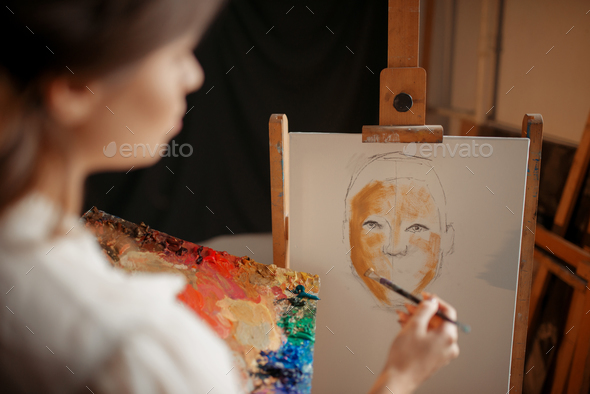 Female artist with color palette and brush - Stock Photo - Images