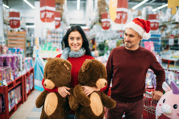 Couple with two big plush bears in supermarket - Stock Photo - Images