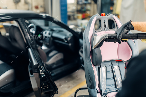 Carwash, removing of dust and dirt from child seat - Stock Photo - Images