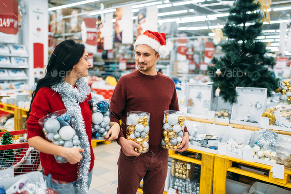 Young couple with boxes full of Christmas balls - Stock Photo - Images