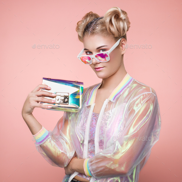 Blonde young woman in holographic jacket - Stock Photo - Images