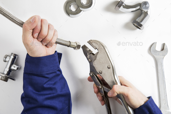 hands of plumber at work - Stock Photo - Images