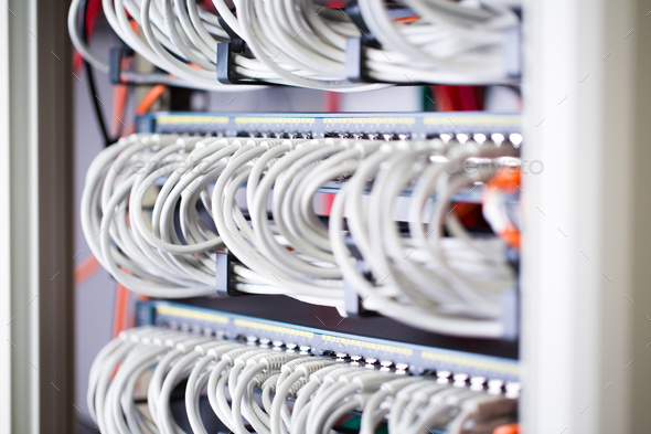 Gigabit network switch and perfect aligned patch cables in datacenter - Stock Photo - Images