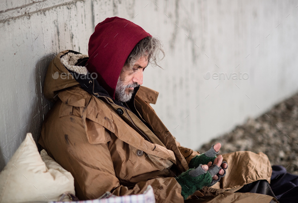 Homeless beggar man sitting outdoors in city asking for money donation. - Stock Photo - Images