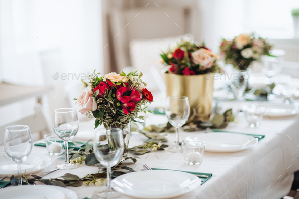 Table set for a meal indoors in a room on a party, a wedding or family celebration.