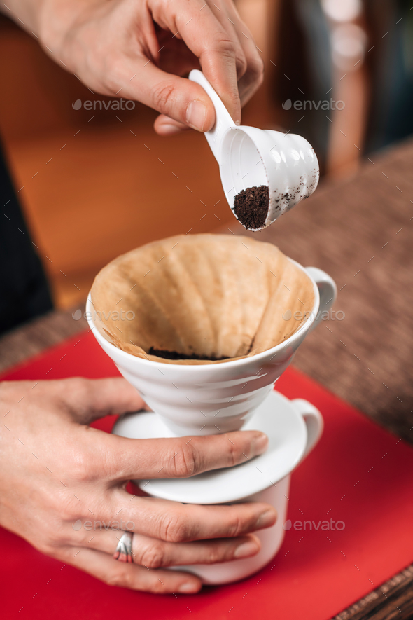 Download Filter Coffee. Pouring Ground Coffee into Manual Drip Coffee Mak Stock Photo by microgen
