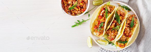 Mexican tacos with chicken meat, corn and tomato sauce. Latin Am