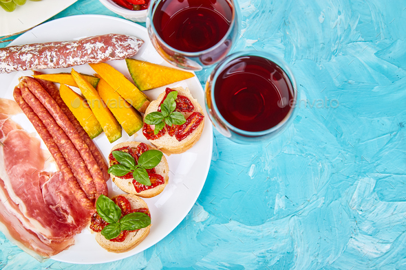 Italian antipasti wine snacks set. Brushettas on blue background. - Stock Photo - Images