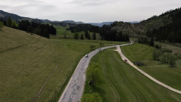 VW Van Driving in Alone Road Sunny Drone Shot alt