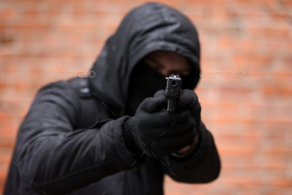 Man in black mask with handgun