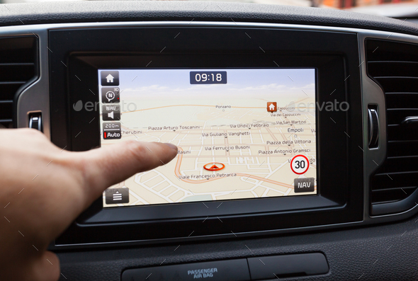 Navigation panel inside a car. Finger pointing on destination po