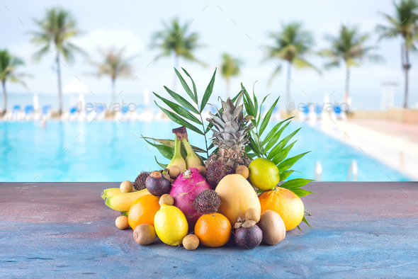 Assorted tropical fruits on the beach orange , pineapple, lime, mango, dragon fruit, orange, banan - Stock Photo - Images