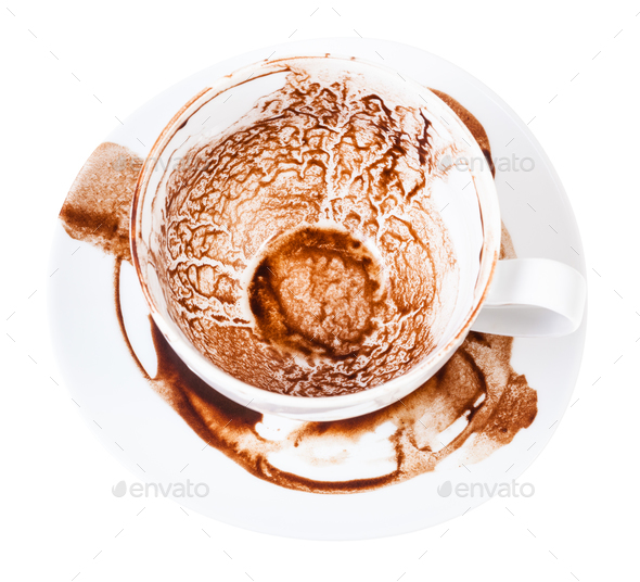 cup on saucer with pattern of carob sediments - Stock Photo - Images