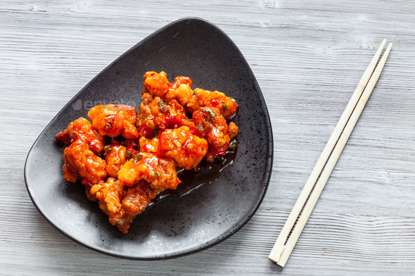 spicy fried Chicken with chopsticks close up - Stock Photo - Images