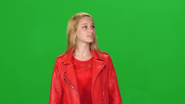 Portrait of Blonde Girl Calmly Walking on Green Screen Background. Chroma Key. Front View. Slow alt