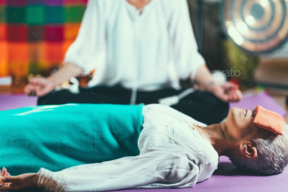 Senior woman on a guided meditation class - Stock Photo - Images