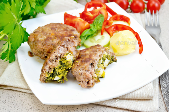 Cutlets stuffed in plate on stone table - Stock Photo - Images