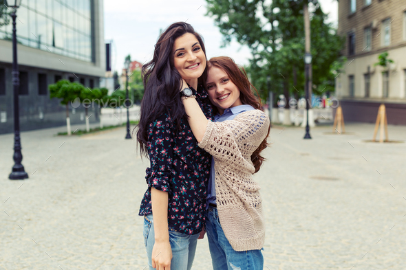 Carefree smiling sisters hugging and having fun together - Stock Photo - Images