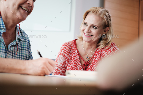 Manager Working As Banking Broker With Old Couple Signing Contract