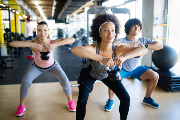 Group of healthy fit people training in gym Stock Photo by nd3000 ...