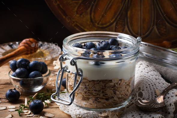 Muesli with yogurt and blue berries in glass jar. - Stock Photo - Images