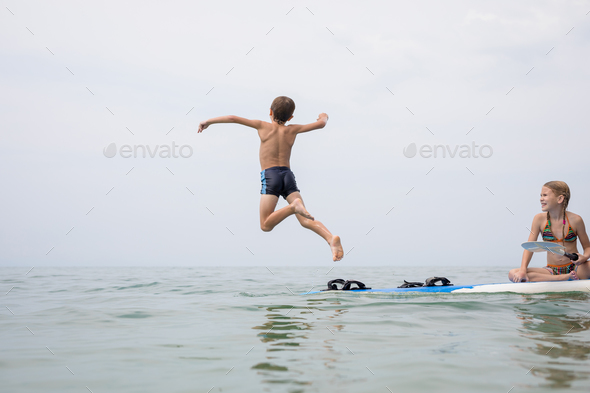 Happy children playing on the beach at the day time. - Stock Photo - Images